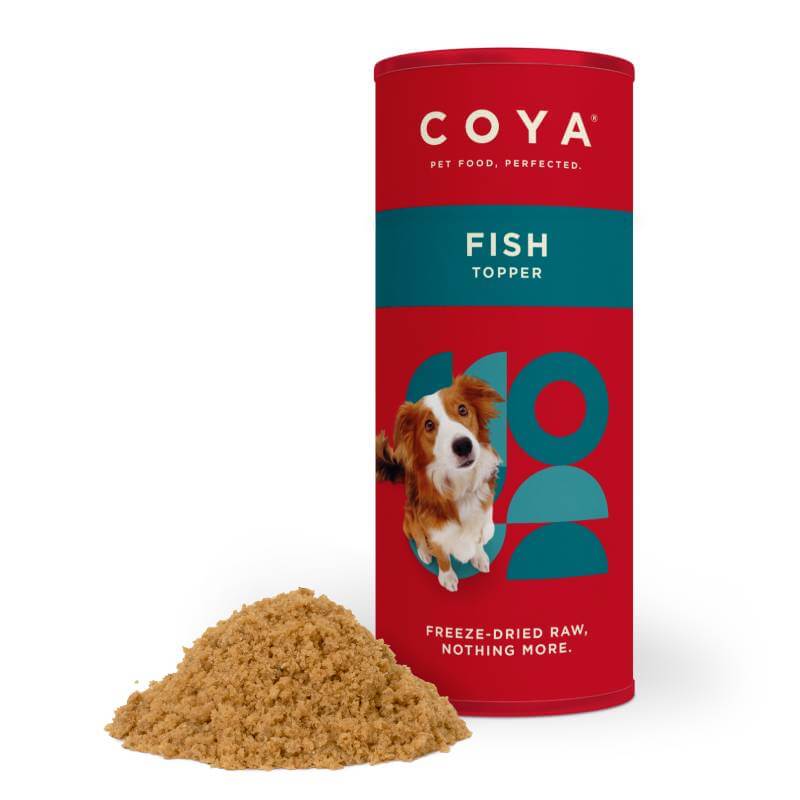 Coya Adult Dog Topper Fish 50g in a red container with food beside it.