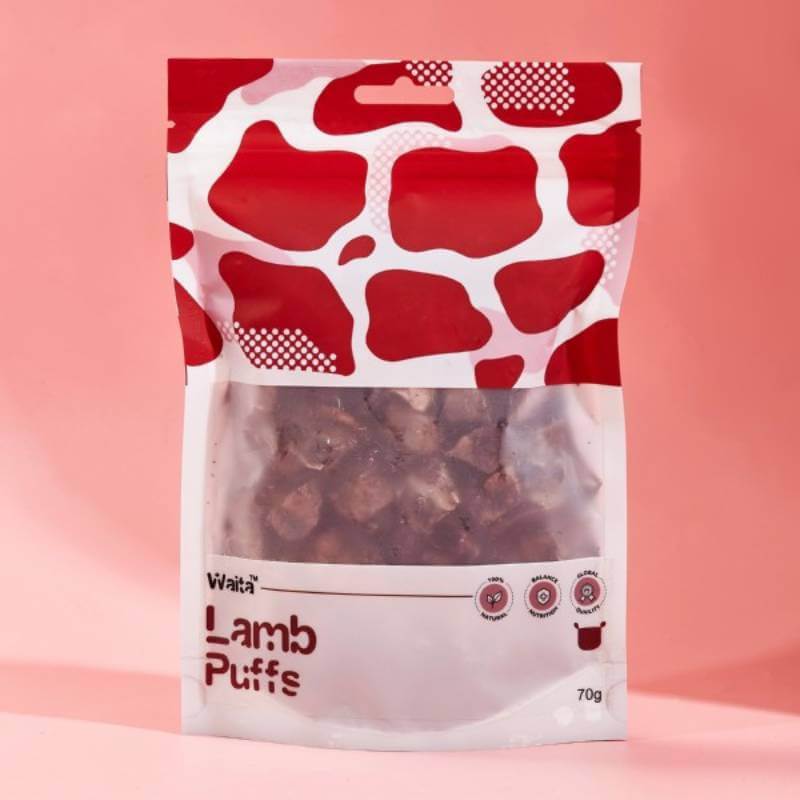A 70g bag of Waita Air Dried Lamb Puffs Dog &amp; Cat treats in cow-print packaging.
