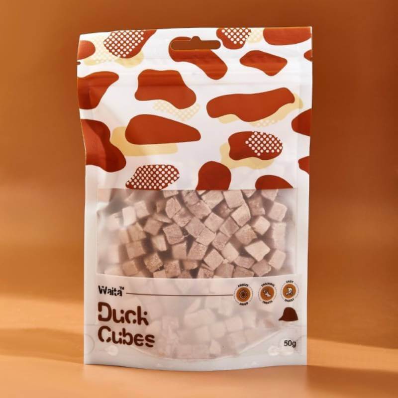 Waita Freeze Dried Duck Cubes Dog &amp; Cat 50g, a novel protein treat, on a brown background.
