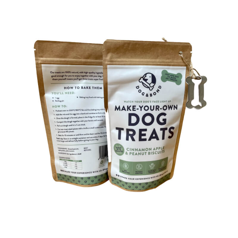 Two pouches of Dog & Bond Dog Treat Mix Cinnamon Apple & Peanut with cutter.