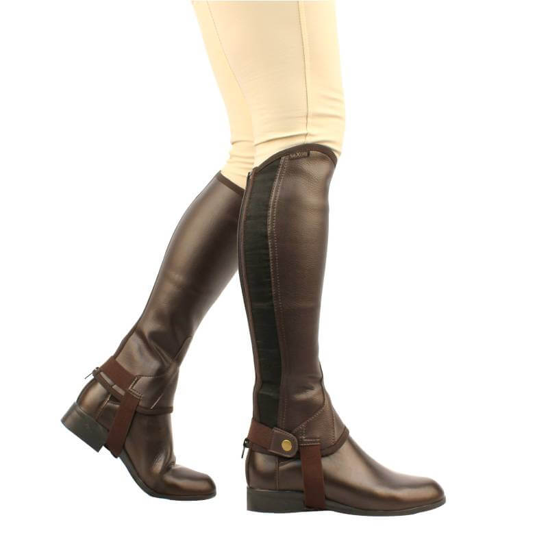 Child in Saxon Equileather Half Chaps (Brown) and beige pants, shown from the side.
