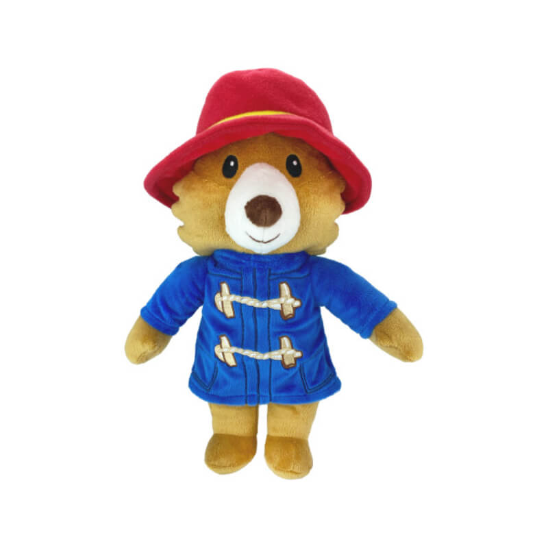Happy Pet Paddington Bear Dog Toy in a blue coat and red hat against a white background.