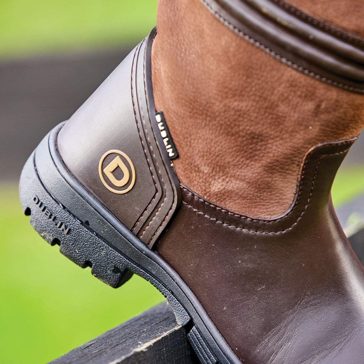 Close-up of Dublin Husk II Boots with RCS footbed on a black surface.