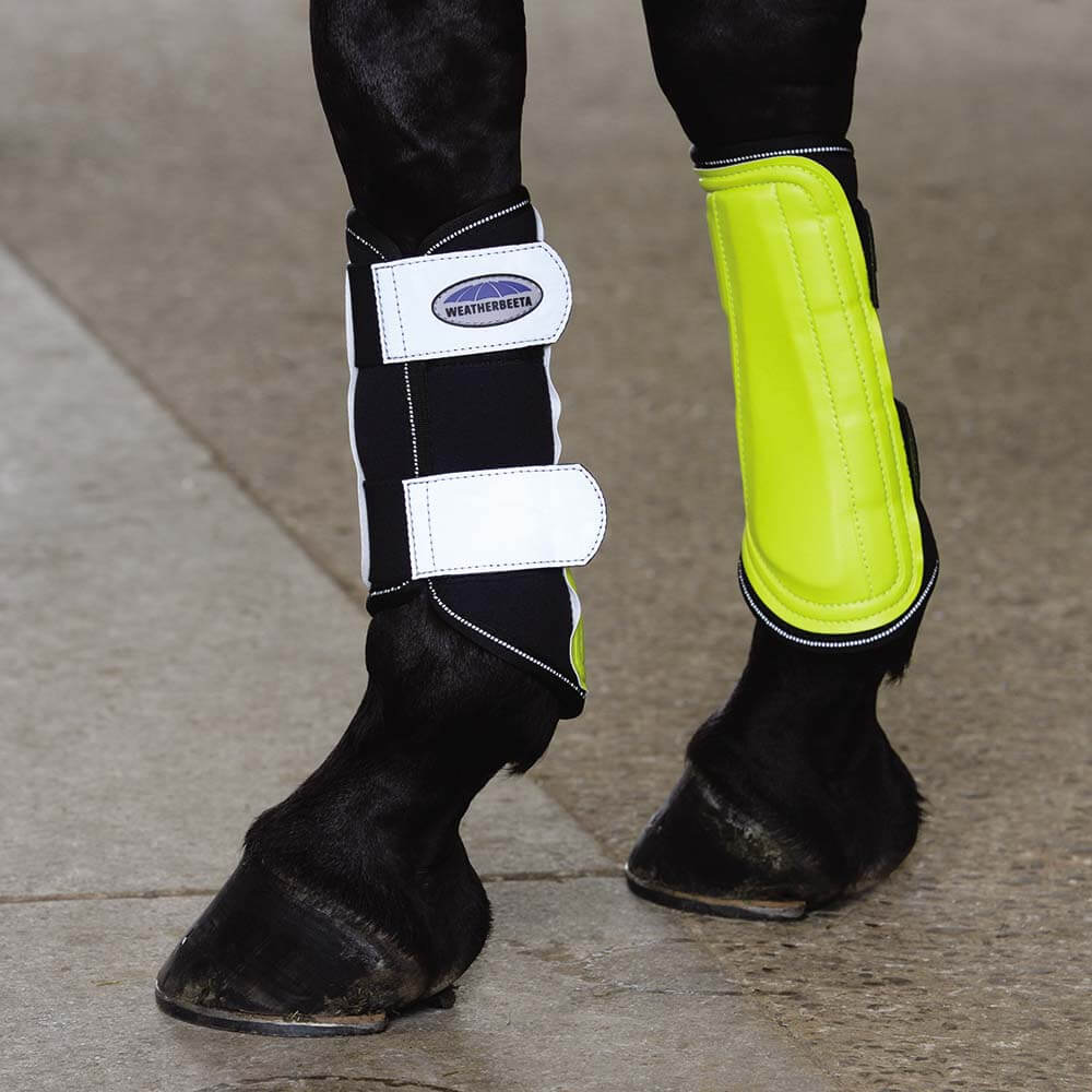 Close-up of Weatherbeeta Reflective Single Lock Brushing Boots in yellow/silver on horse's legs.