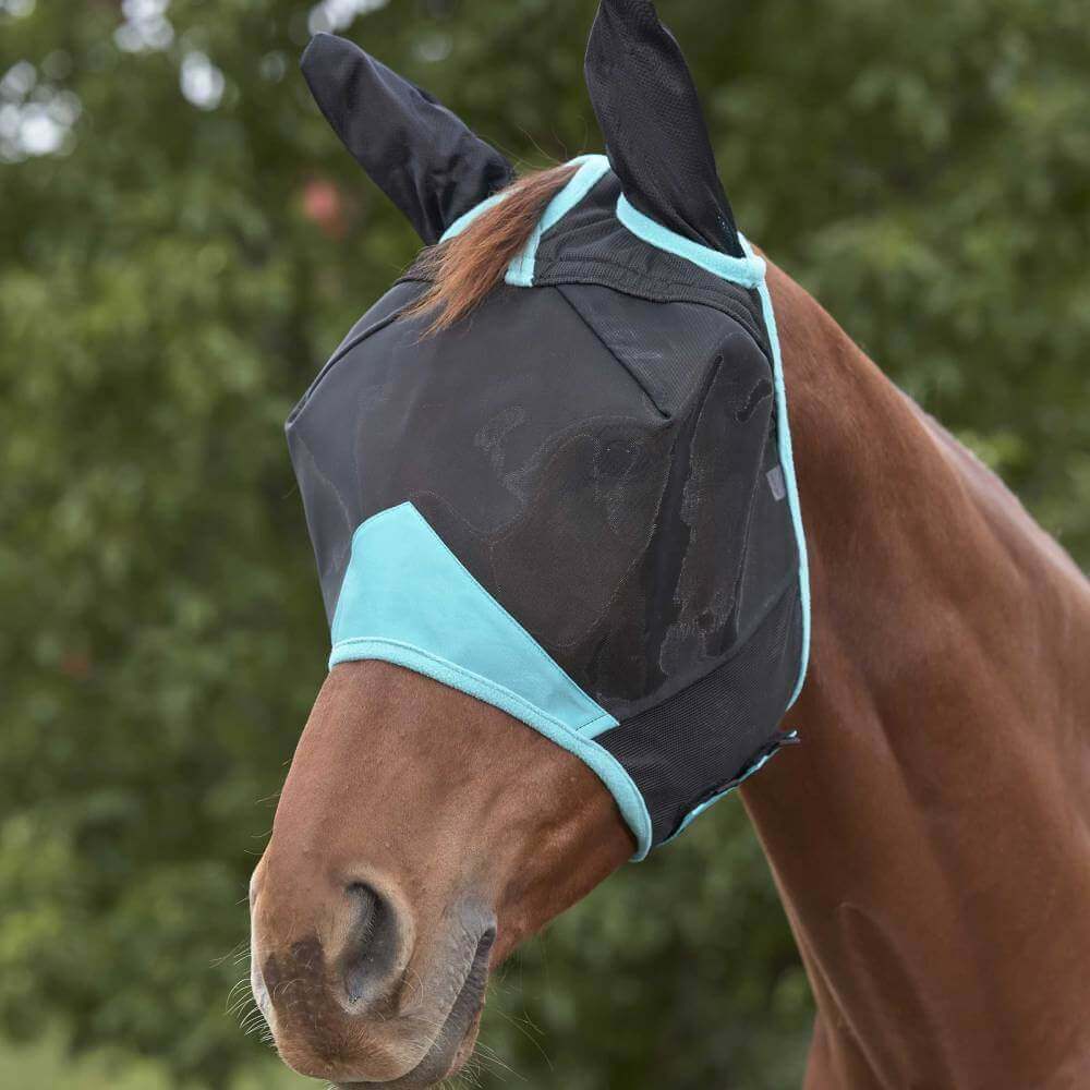 A horse wears the Weatherbeeta Comfitec Deluxe Fine Mesh Mask with Ears outdoors.