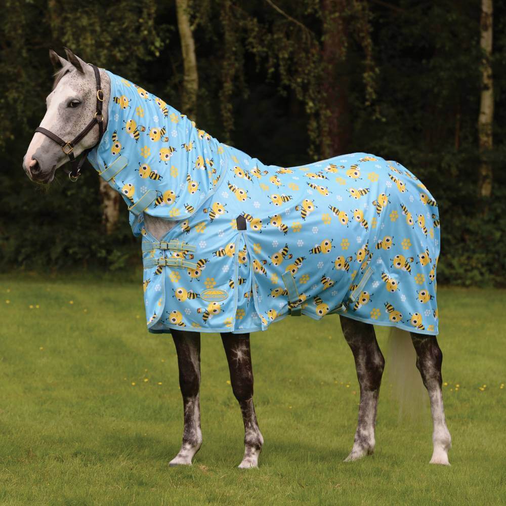 Gray horse in a Weatherbeeta Comfitec Essential Mesh II Bee Print sheet stands on grass.