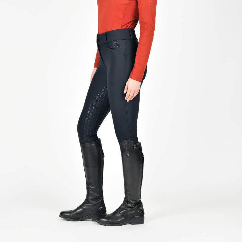 Person in black Weatherbeeta Thermal Waterproof Breeches and a red long-sleeve shirt on white.