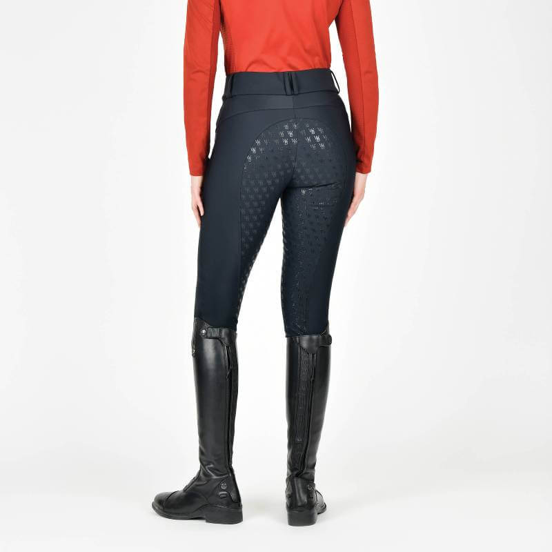 Woman wears Weatherbeeta Thermal Waterproof Breeches Black, back view.