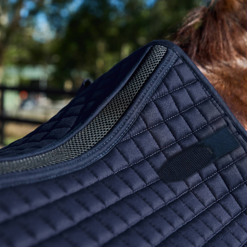 Close-up of a Weatherbeeta Prime Air-Tec All Purpose Saddle Pad Navy on a horse outdoors.