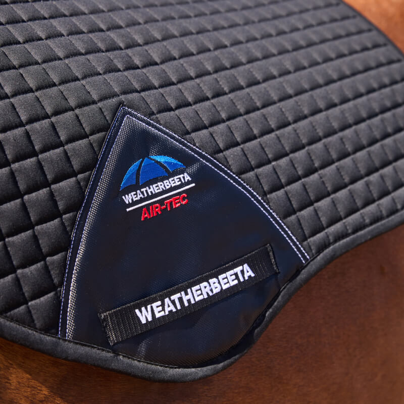 Weatherbeeta Prime Air-Tec Jump Shaped Saddle Pad Black on horse, logo patch visible.