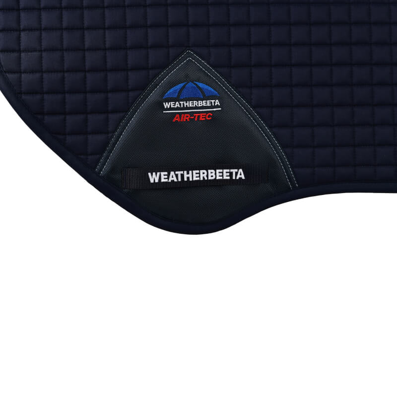 Close-up of a Weatherbeeta Prime Air-Tec Jump Shaped Saddle Pad in navy with brand logo.
