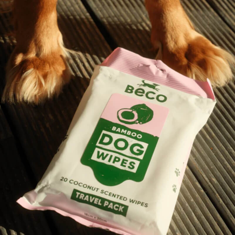 Beco Bamboo Dog Grooming Travel Wipes Coconut Scented 20pk near a dog's paws on the floor.