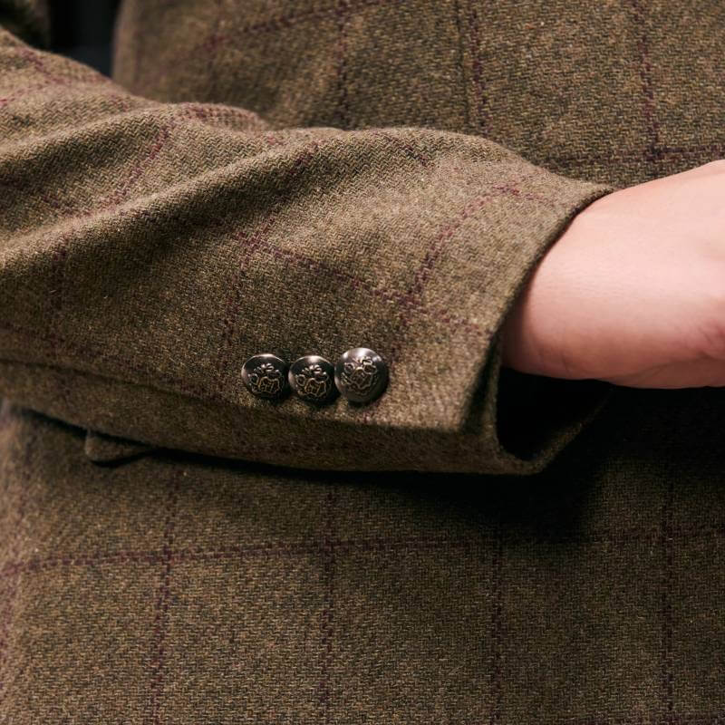 Close-up of a hand in the Dublin Albany Tweed Suede Collar Tailored Jacket with 3 metallic buttons.